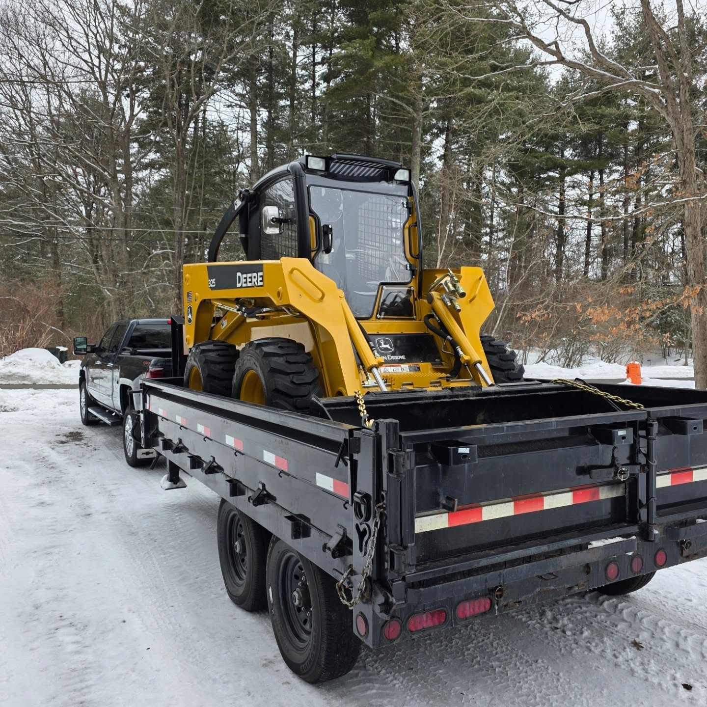 Truck with a skid steer loaded on the trailer